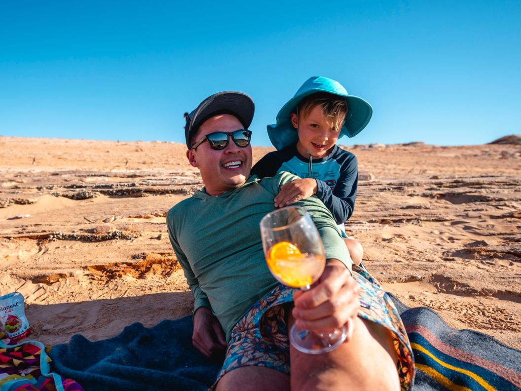 Father and son enjoy the sunshine on a desert mesa. 